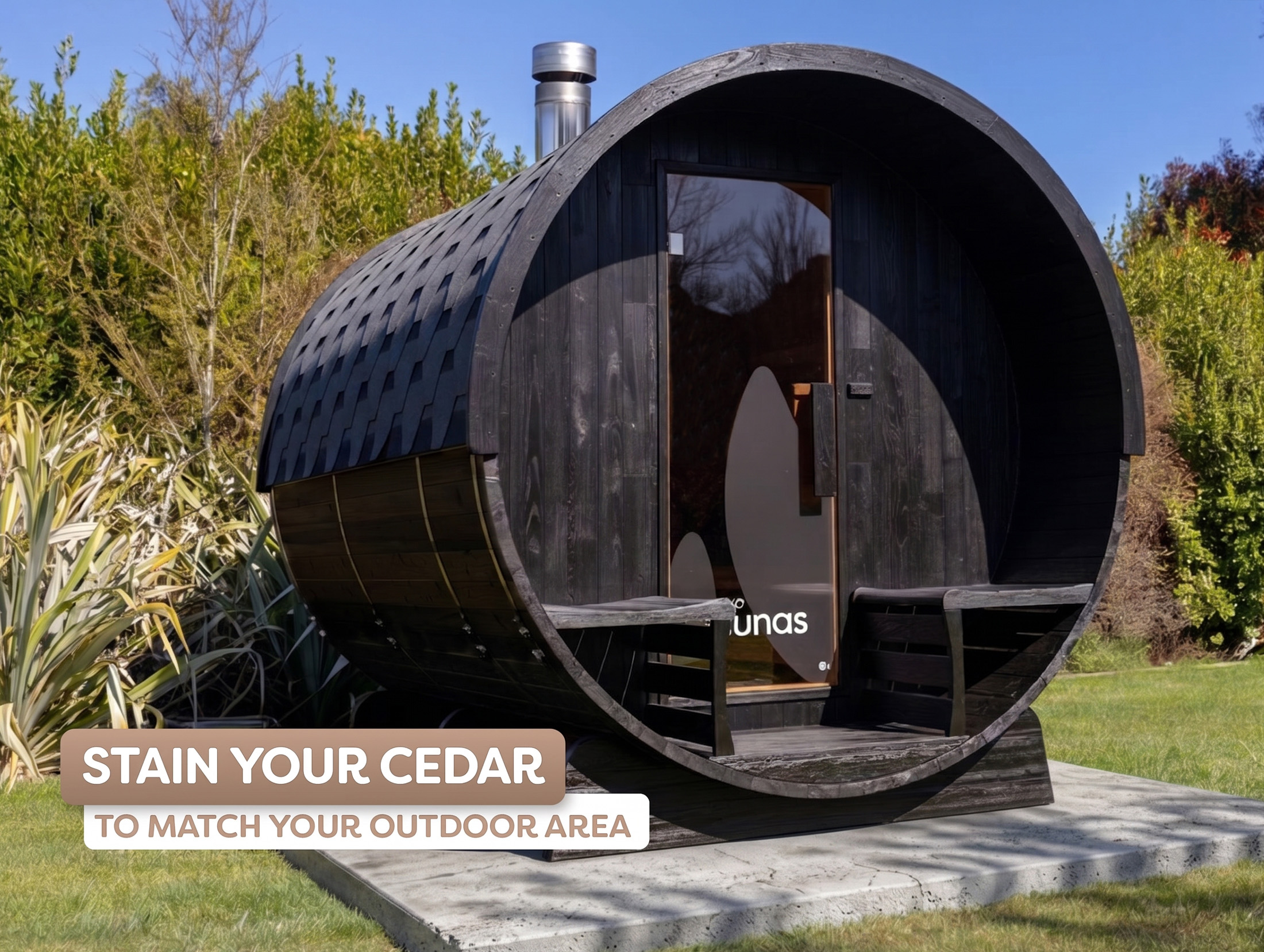 A black-stained barrel-shaped outdoor building with a glass door and benches sits on a concrete base in a landscaped garden, with text reading "Stain your cedar to match your outdoor area."