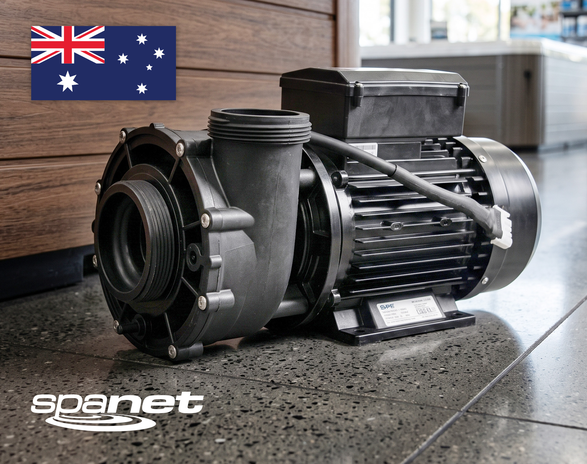 A black water pump sits on a polished floor with a wooden wall in the background. The Australian flag appears in the top left corner, and the "spanet" logo is in the bottom left corner.