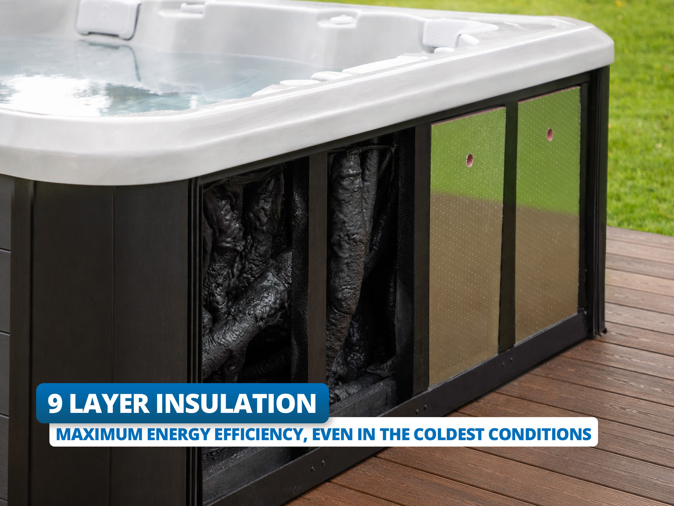 Close-up of a hot tub with a panel removed, revealing thick black insulation and shiny reflective panels inside the frame. Text overlay reads, "9 Layer Insulation. Maximum energy efficiency, even in the coldest conditions."