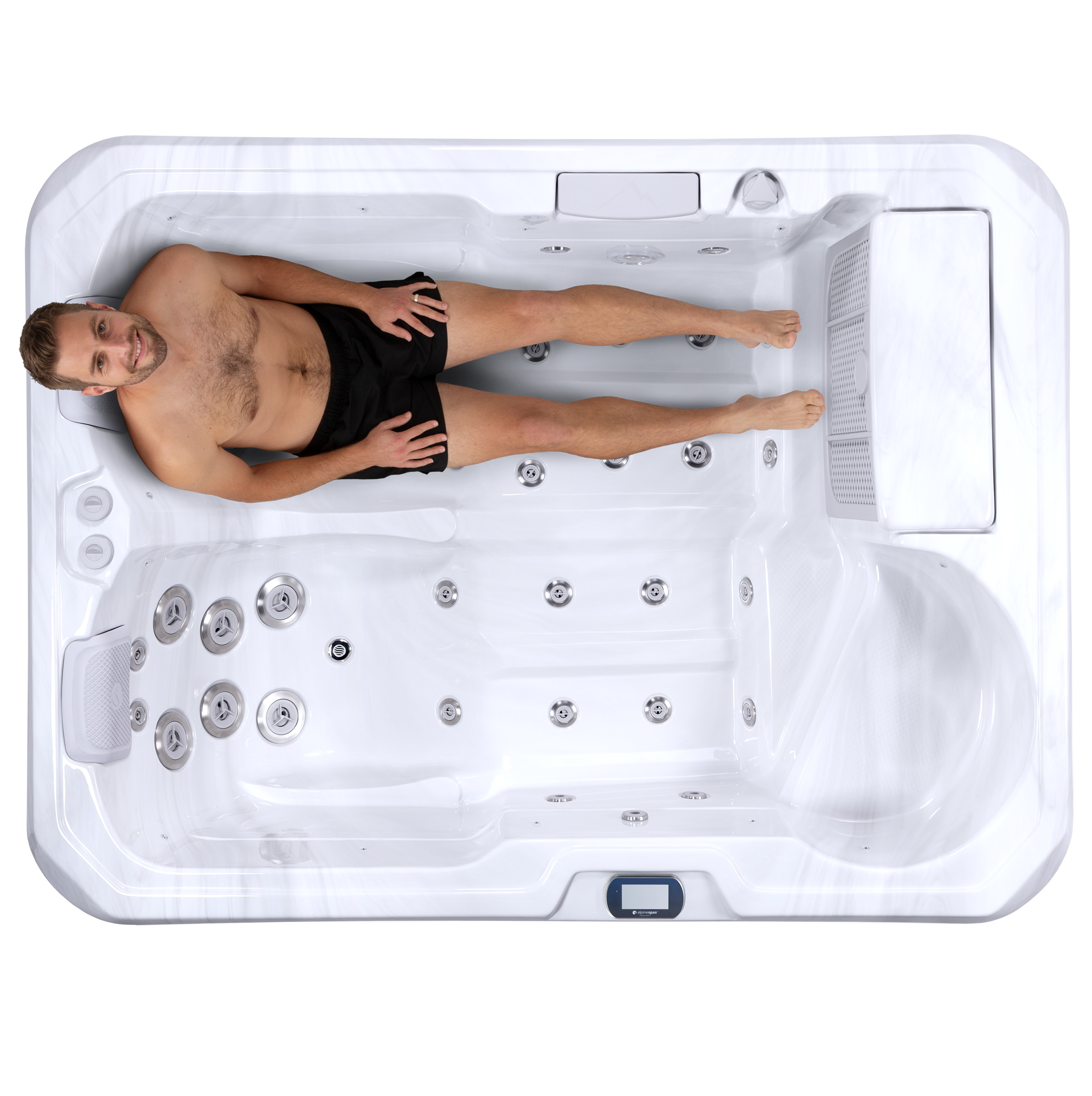 Top-down view of a man in swim trunks reclining in a white hot tub lounger with multiple jets.